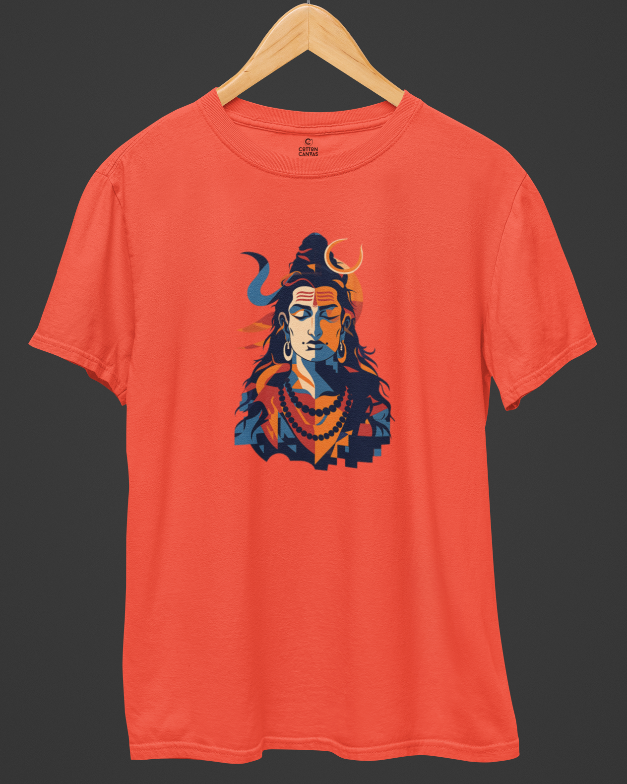 Orange t-shirt with a graphic design of a face on a wooden hanger against a dark background