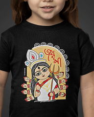 Child wearing a black t-shirt with a colorful graphic design on a dark background