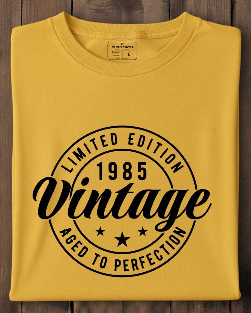 Yellow t-shirt with black text on a wooden surface