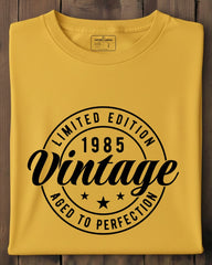 Yellow t-shirt with black text on a wooden surface
