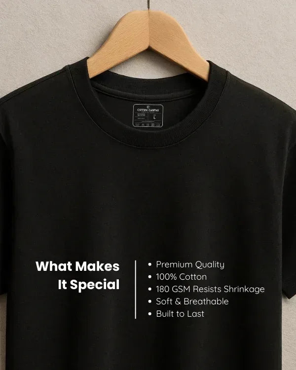 Black t-shirt on a hanger with text detailing its features.